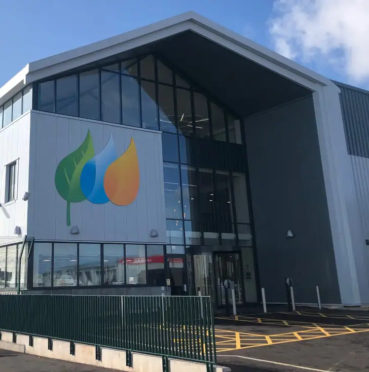a commercial building with a pitched roof, large windows and the EA1 logo.