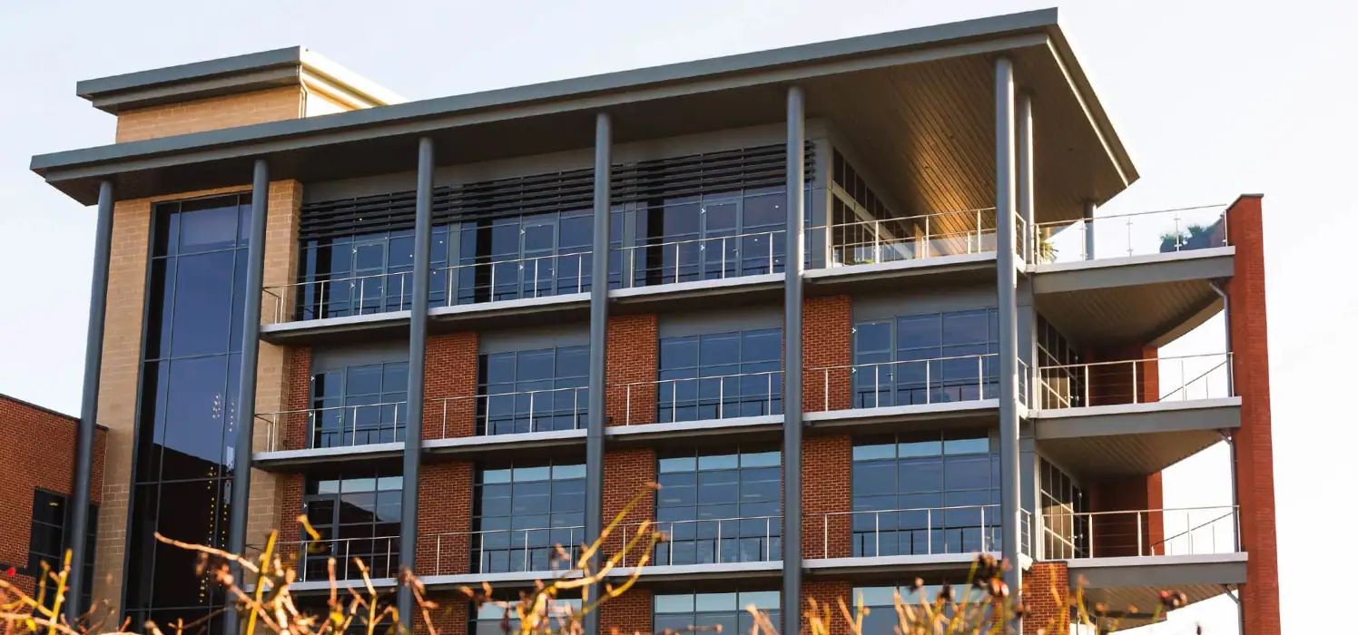 a modern commercial building with large windows and balconies.